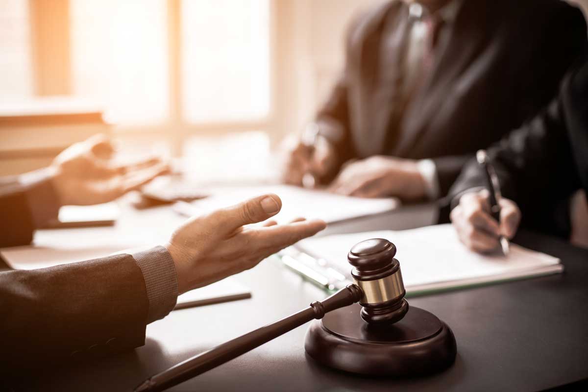 people at desk resolving legal issue